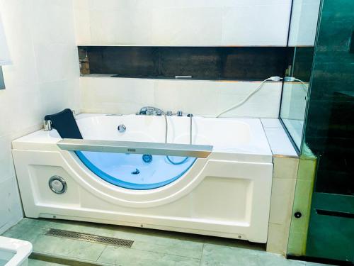 a bathroom with a bath tub with a sink at Impeccable 2-Bed Apartment in Lekki With Snooker in Lekki