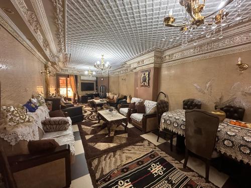 a living room with couches and tables and a ceiling at Bab Al Sharia - Lux Apartment in Minyā al Qamḩ