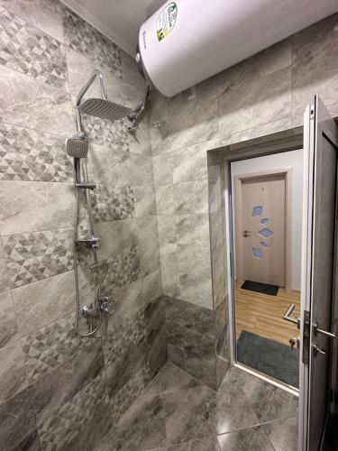 a bathroom with a shower with a glass door at Utopia Apartment 3, by LMG in Hisarya