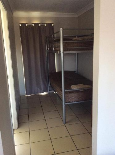 a room with two bunk beds in a room at The Gallery Motor Inn in Dalby