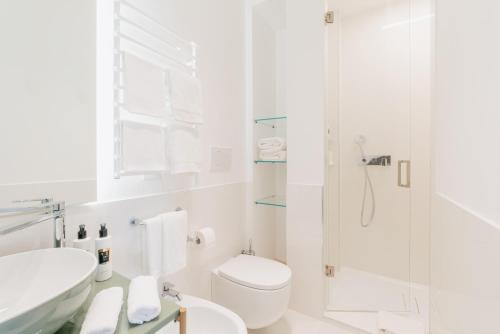 a white bathroom with a shower and a toilet at Palazzo M Capri in Capri