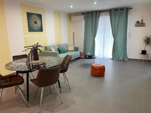 a living room with a table and a couch at Chez Mathieu in Saint-Dizier