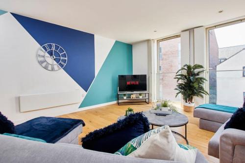 a living room with a couch and a tv at Swanky city centre apartment in Lincolnshire