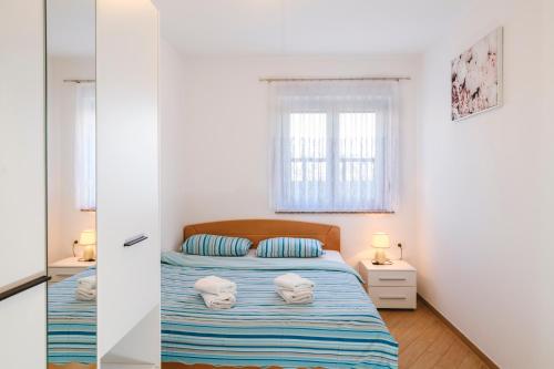 a bedroom with a bed with towels on it at Apartments Mirela in Koper