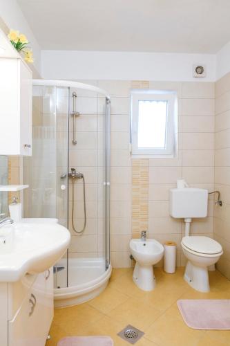 a bathroom with a toilet and a shower and a sink at Apartments Mirela in Koper