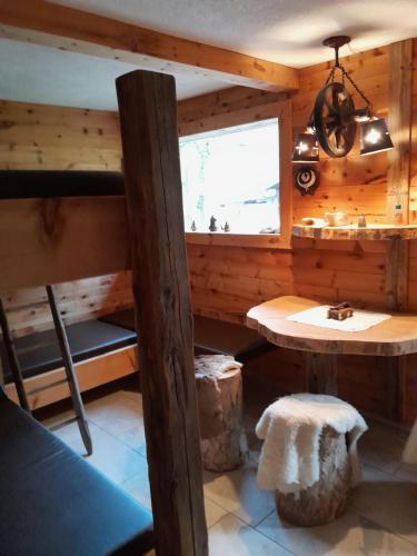 a room with a bunk bed and a table at Wildauhof - Bauernhaus in Fügenberg