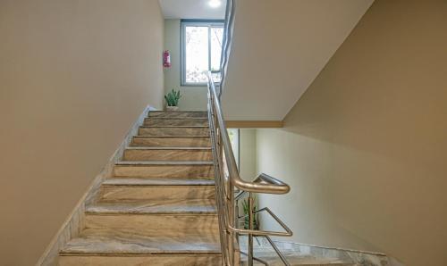 a staircase in a house with a metal handrail at Treebo Gyani's in Jamshedpur