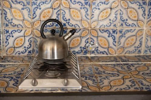 a tea kettle sitting on top of a stove at Castello di Bibbione in San Casciano in Val di Pesa