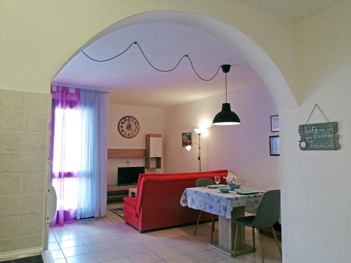 a living room with a red couch and a table at Apartment Suzie Q - Intermezzo with sea view in Rabac