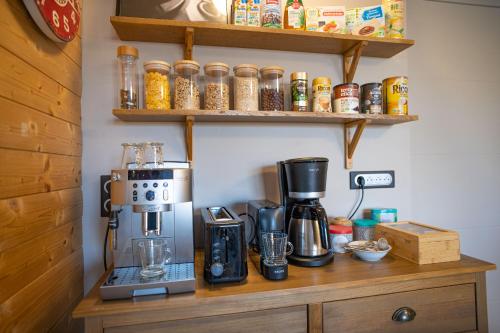 a coffee maker sitting on top of a wooden counter at Le jardin des 4 saisons in Le Mans