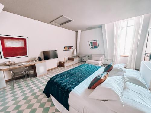 a hotel room with a large bed and a desk at B&B Château Valmy - Teritoria in Argelès-sur-Mer