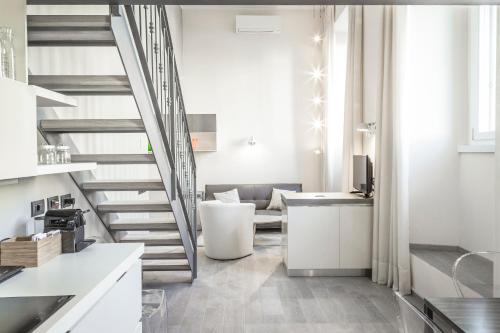 a kitchen with a staircase and a living room at Brera Apartments in San Marco in Milan