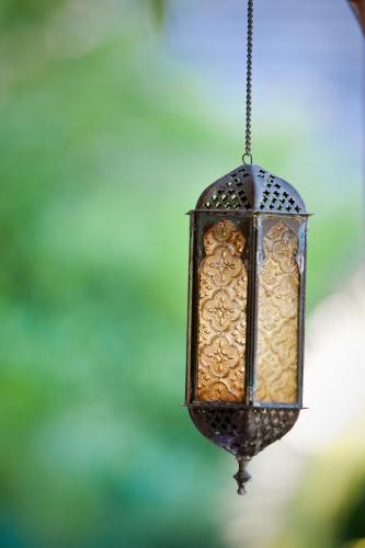 a close up of a lantern hanging from a chain at Point Grace in Grace Bay