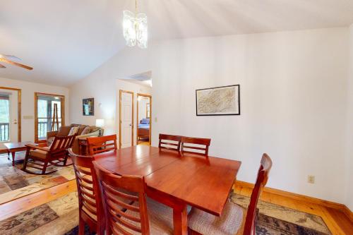 a dining room with a wooden table and chairs at Raven's Respite in Saluda