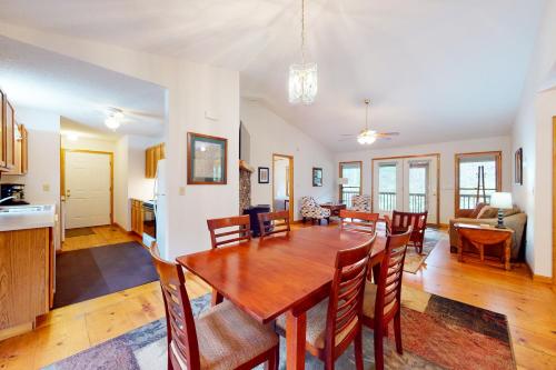 a dining room and living room with a table and chairs at Raven's Respite in Saluda