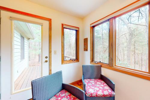 two chairs sitting in a room with windows at Raven's Respite in Saluda