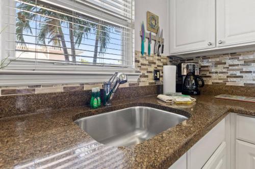 a kitchen counter with a sink and a window at 107F Barefoot Beach Resort in Clearwater Beach