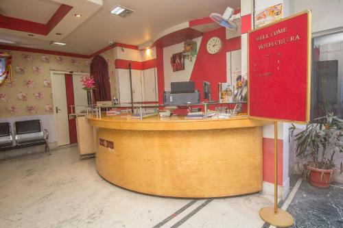 a bar in a restaurant with a counter at OYO Hotel Chitra in Alīpur Duār
