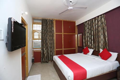 a bedroom with a bed and a flat screen tv at Flagship Vibrant Guest House in Dānāpur