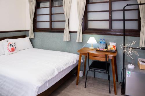 Cama o camas de una habitación en 櫻花樹夏民宿