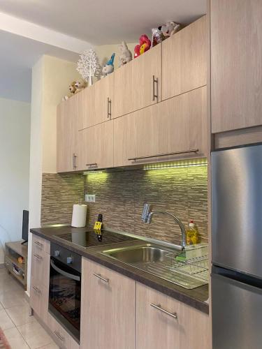 a kitchen with a sink and a stainless steel refrigerator at Aegean View Seaside Apartment in Kavala