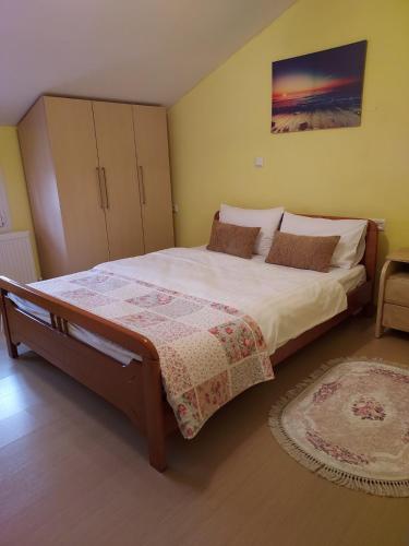a bedroom with a large bed and a rug at Aegean View Seaside Apartment in Kavala