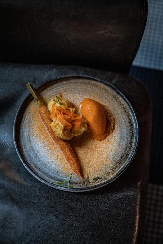 a plate of food on a table with a dessert at Hotel Les Bains Paris in Paris