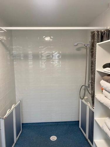 a bathroom with a shower and towels on a wall at 2 bed house sleeps 4-5 in Liverpool
