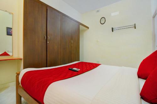 um quarto com uma cama e um armário de madeira em Infosys Thoraipakkam Near Ecr Beach em Chennai