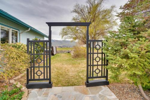 a gate to a yard with a garden at 30 Mins to Leavenworth Home with Hot Tub and Yard! in East Wenatchee
