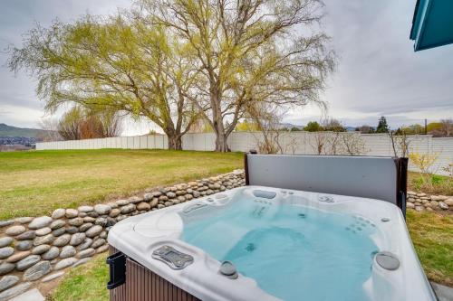 a hot tub in a backyard with a tree at 30 Mins to Leavenworth Home with Hot Tub and Yard! in East Wenatchee