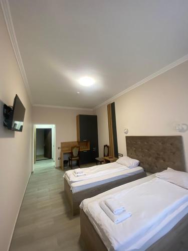 a hotel room with two beds and a television at RIVER SIDE in Polyana