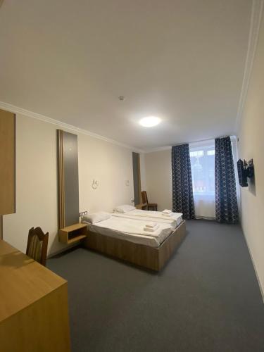 a bedroom with a large bed and a mirror at RIVER SIDE in Polyana