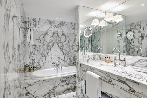a bathroom with two sinks and a large mirror at De L’Europe Amsterdam – The Leading Hotels of the World in Amsterdam