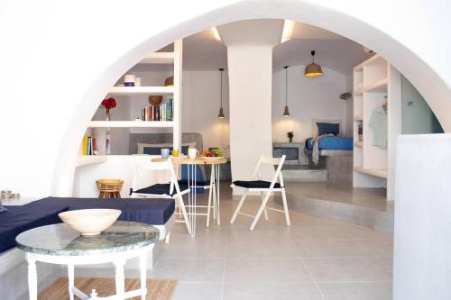 a kitchen and living room with a table and chairs at Traditional Arch House Paros in Márpissa