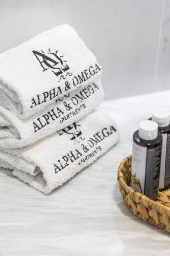 a pile of towels sitting next to a basket with two bottles at Alpha & Omega in Karpathos Town