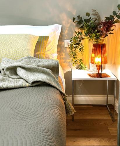 a bedroom with a bed and a nightstand with a lamp at Room114 - Studio apartment near the center in Florence