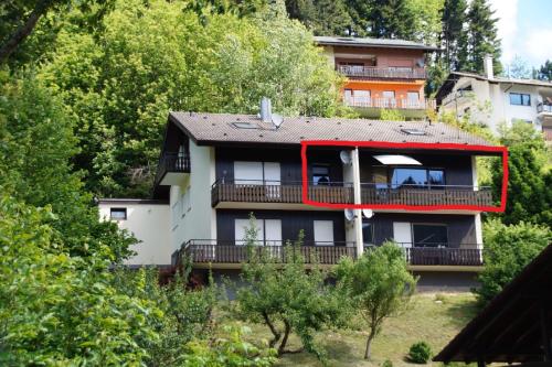 a building with a red frame on the side of it at Ferienwohnung Wilde7 in Seebach