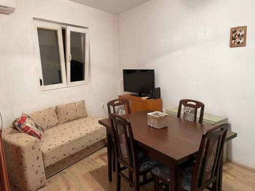 a living room with a table and a couch at Apartman u blizini centra grada in Belgrade