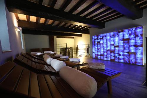 a room with a bunch of chairs and a large screen at Castello di Baccaresca in Branca