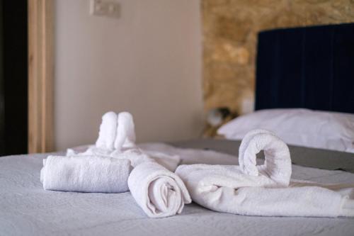 a pile of towels sitting on top of a bed at Royal Stay Luxury Homes in Paphos