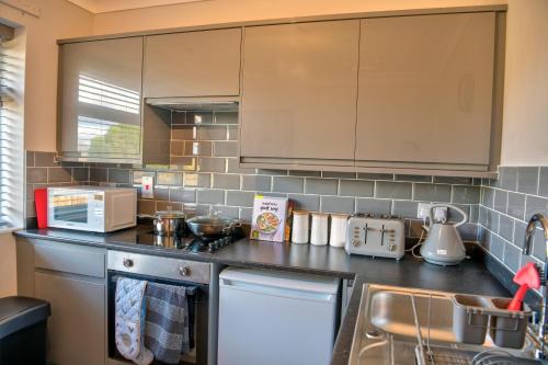 a kitchen with a sink and a counter top at Oakland in Kettering
