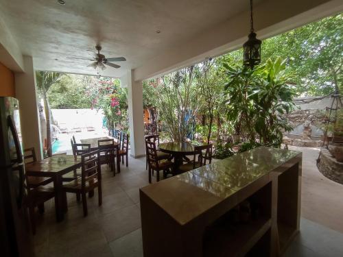 a dining room with tables and chairs and a ceiling fan at Casa Daniels Guesthouse in Valladolid