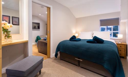 a bedroom with a bed and a large mirror at Barn End in Ambleside