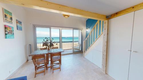 a dining room with a table and a view of the ocean at Pin laricio in Grimaud