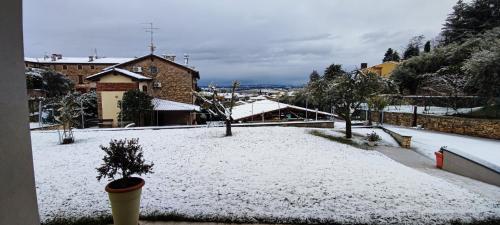 a snow covered yard in front of a building at B&B QUINTARELLI in San Pietro in Cariano