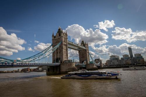 a boat in the water in front of a bridge at Maldron Hotel Finsbury Park, London in London