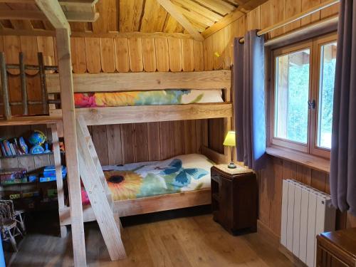 a bedroom with two bunk beds in a cabin at La Fuste des Garceaux in Orconte