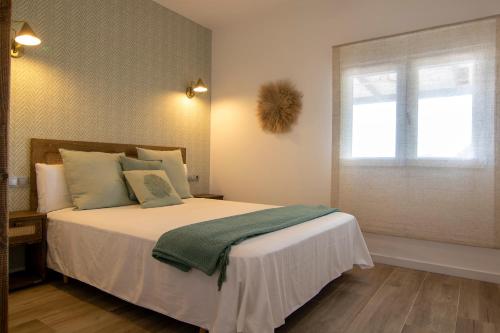 a bedroom with a large bed with a window at La Lagunilla Golf in Candeleda