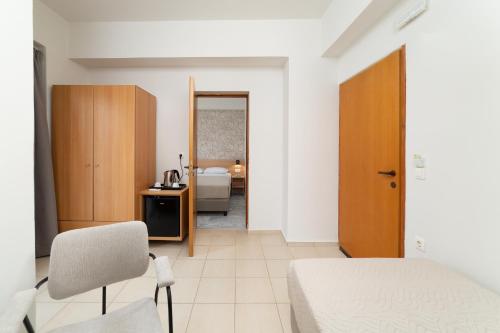 a bedroom with a bed and a desk and a mirror at Emi Seaside in Amoudara Herakliou
